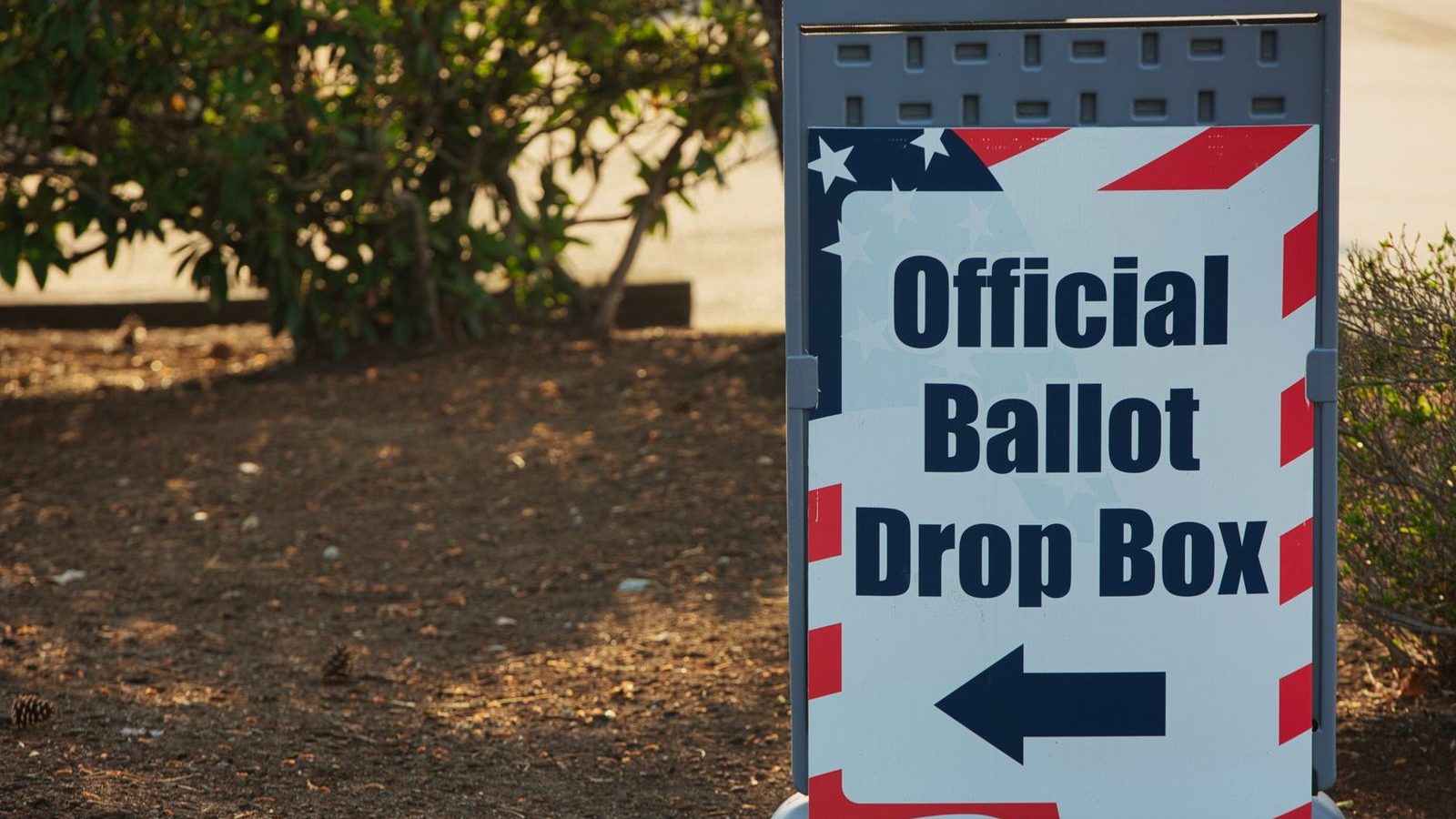 A sign pointing to an official ballot drop box