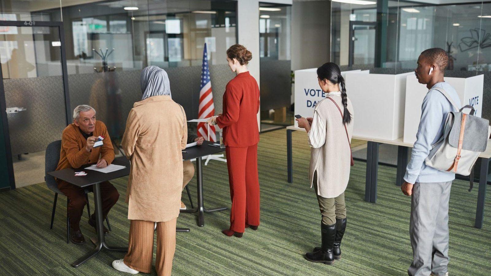 Voters waiting in line at an indoor polling place